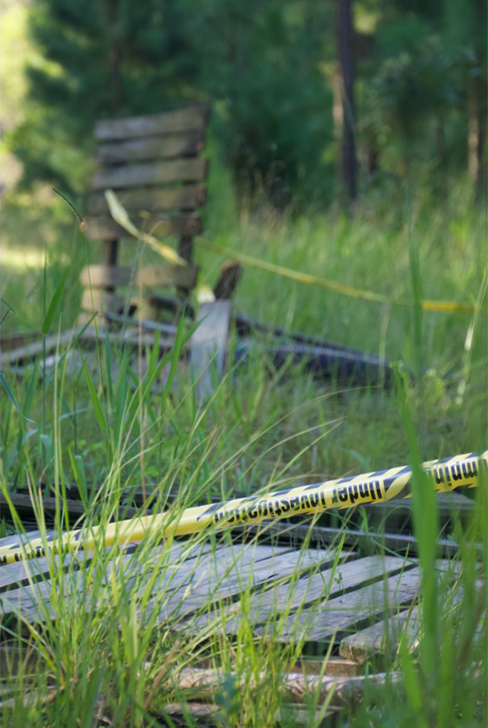 'Under investigation' crime tape encircles a dumped timber structure 