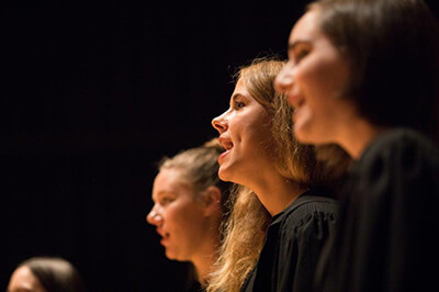 Three female students singing