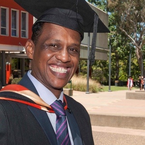 UNE Accounting graduate in graduation cap and gown