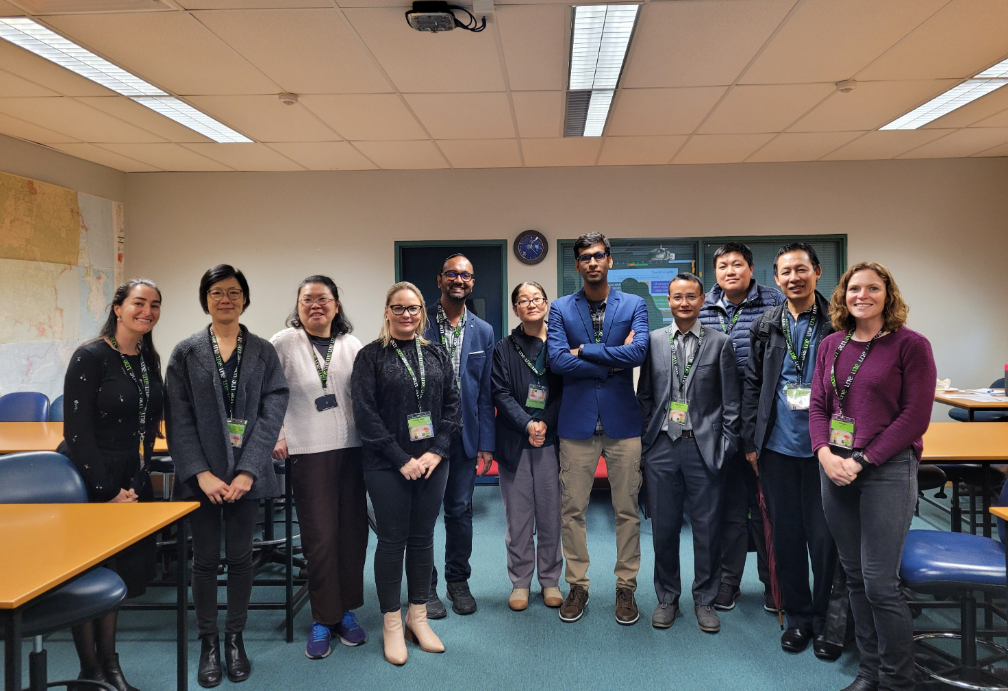 Group photo of post graduate students in a classroom 