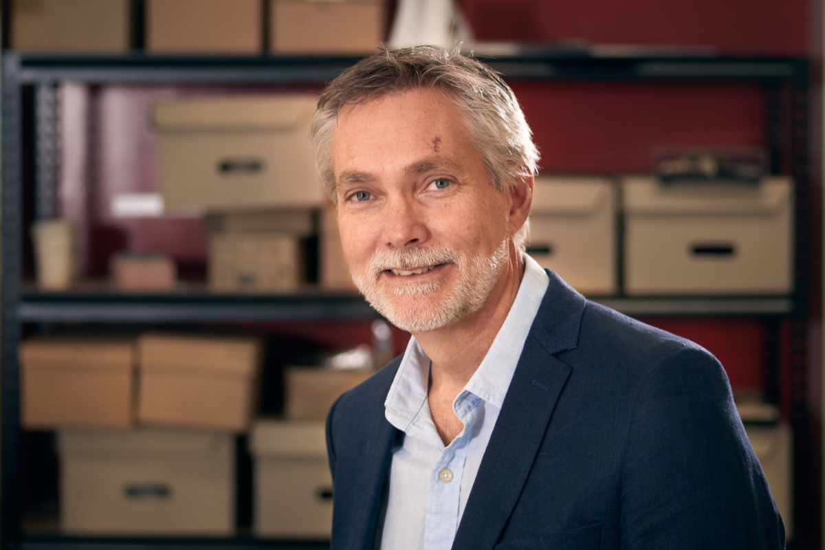 Man standing before archive boxes