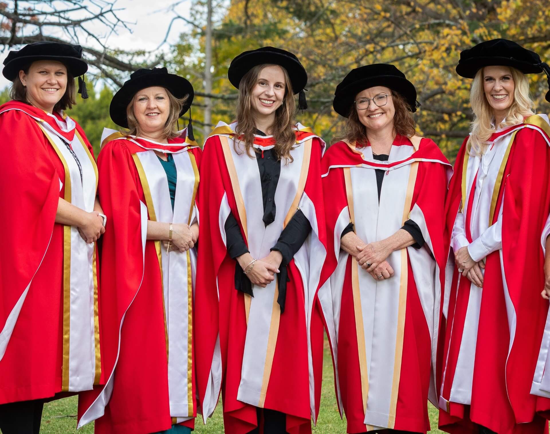 Graduates looking to camera.