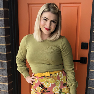 UNE Bachelor of Education (Secondary Arts) student smiles in front of an orange door