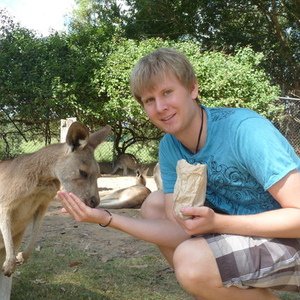 UNE graduate feeding kangaroo