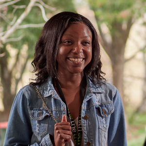 UNE Bachelor of Social Work student Natasha Jutas smiles in denim jacket and UNE lanyard