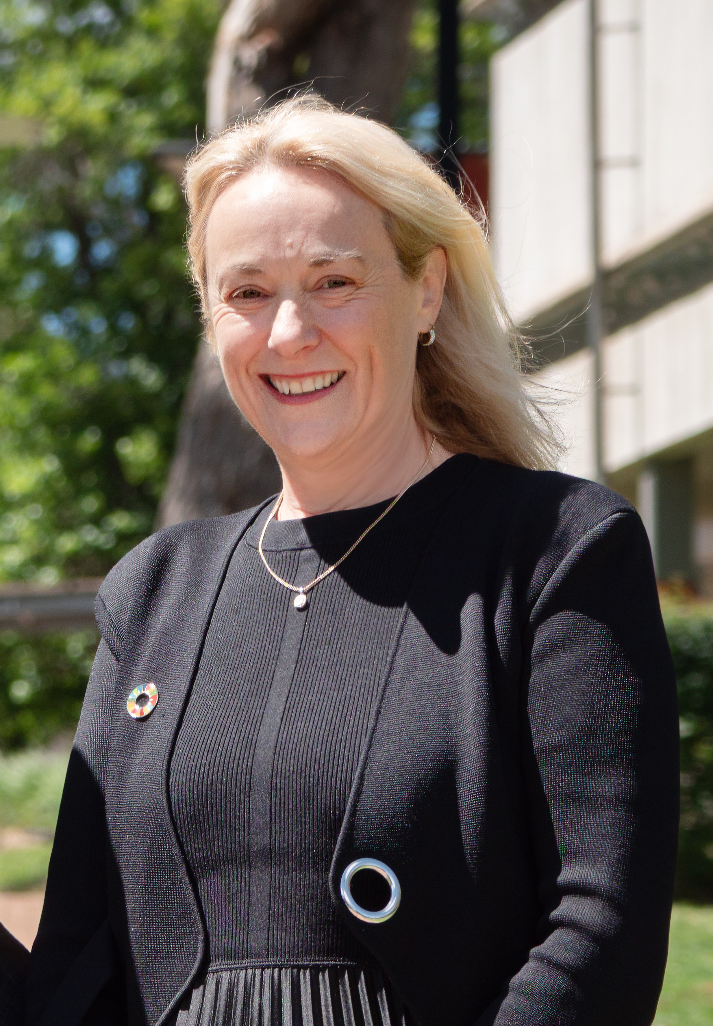 UNE Chancellor, Dr Sarah Pearson, stands on UNE's Graduates' Walk.