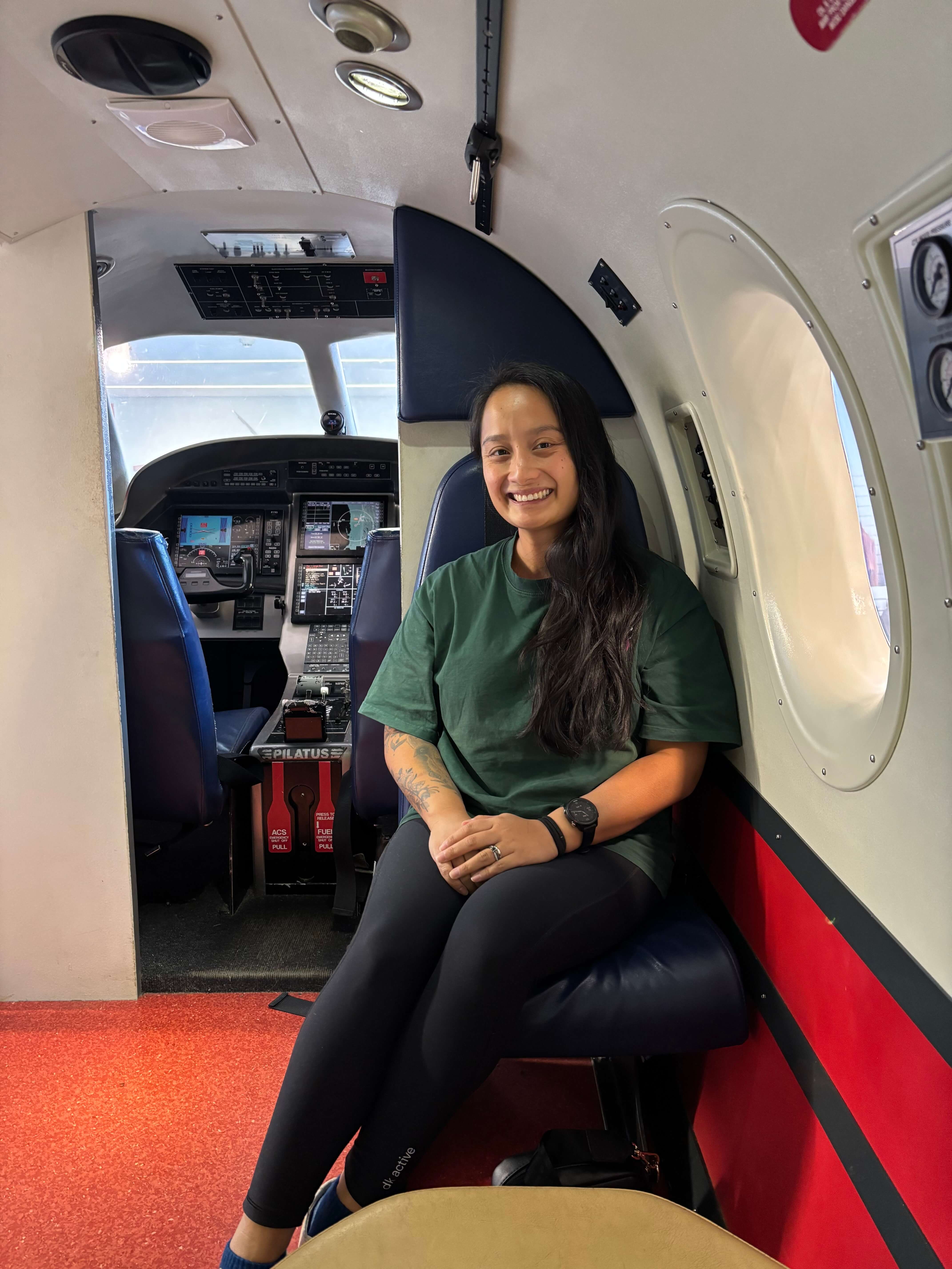 Woman sitting in aircraft.