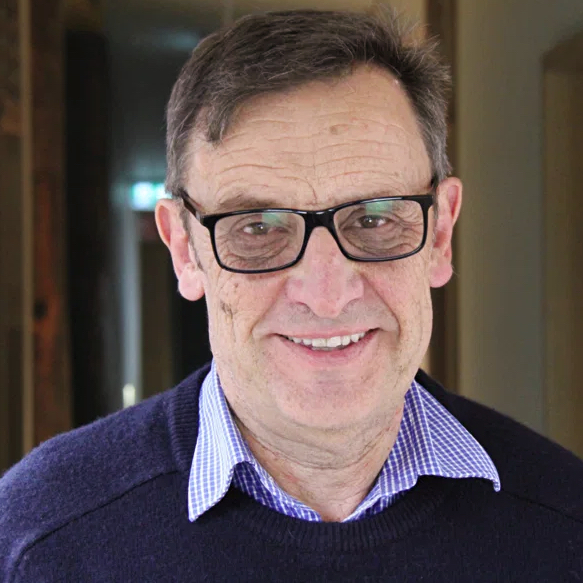 man with spectacles looks at camera