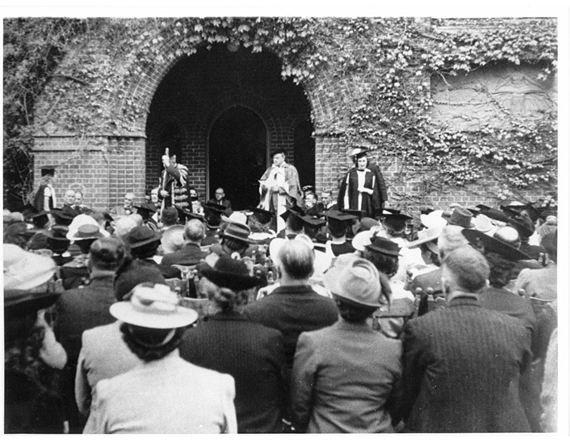 Black and white photo of a graduation outside Booloominbah 
