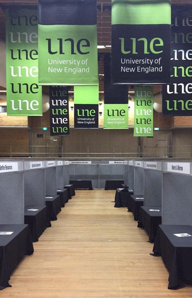 Empty Lazenby hall set up for the careers fair, with UNE signage