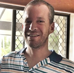 Close up of Graduate Diploma in Urban and Regional Planning graduate Steve Conn in striped shirt