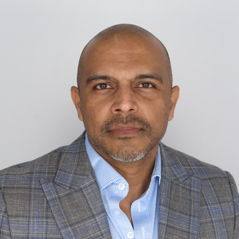 Global tech executive Nik Mohan. Man stares at camera.
