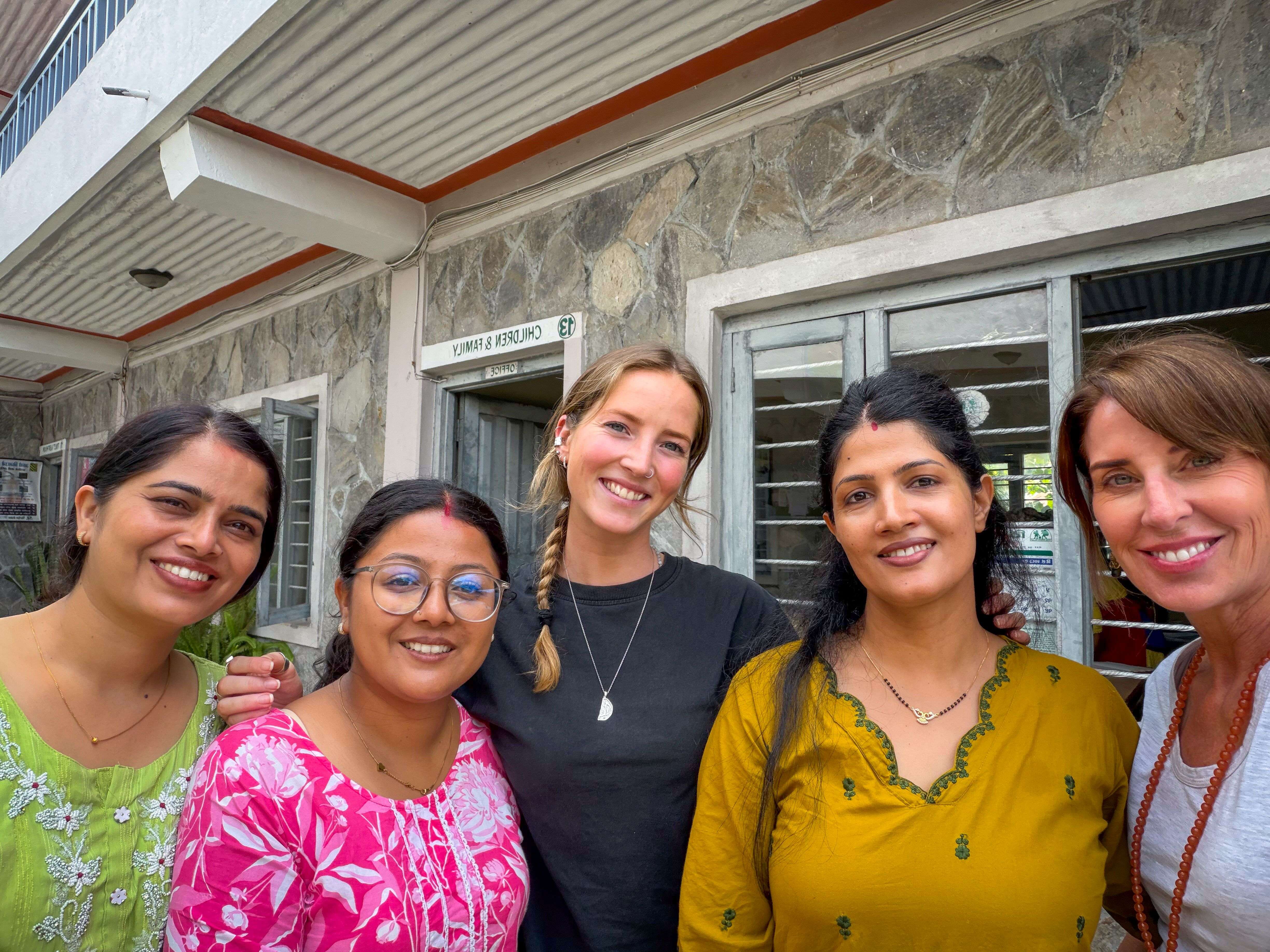 Five women looking at the camera.