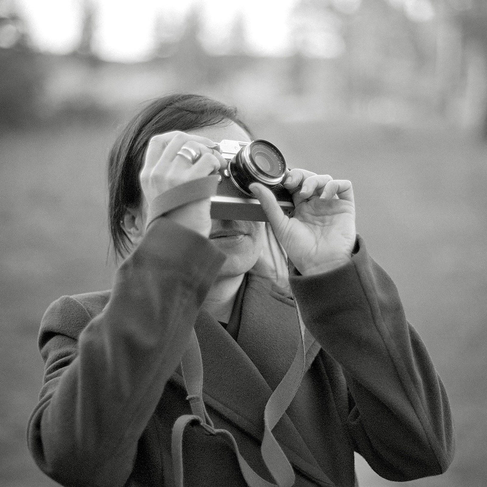 black & white photo of Beth MacRaid O'Loughlin taking a photo