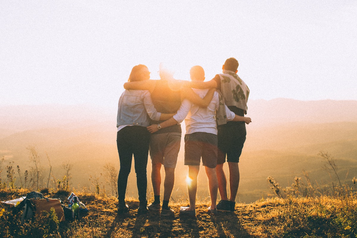four people gathered in late sunlight
