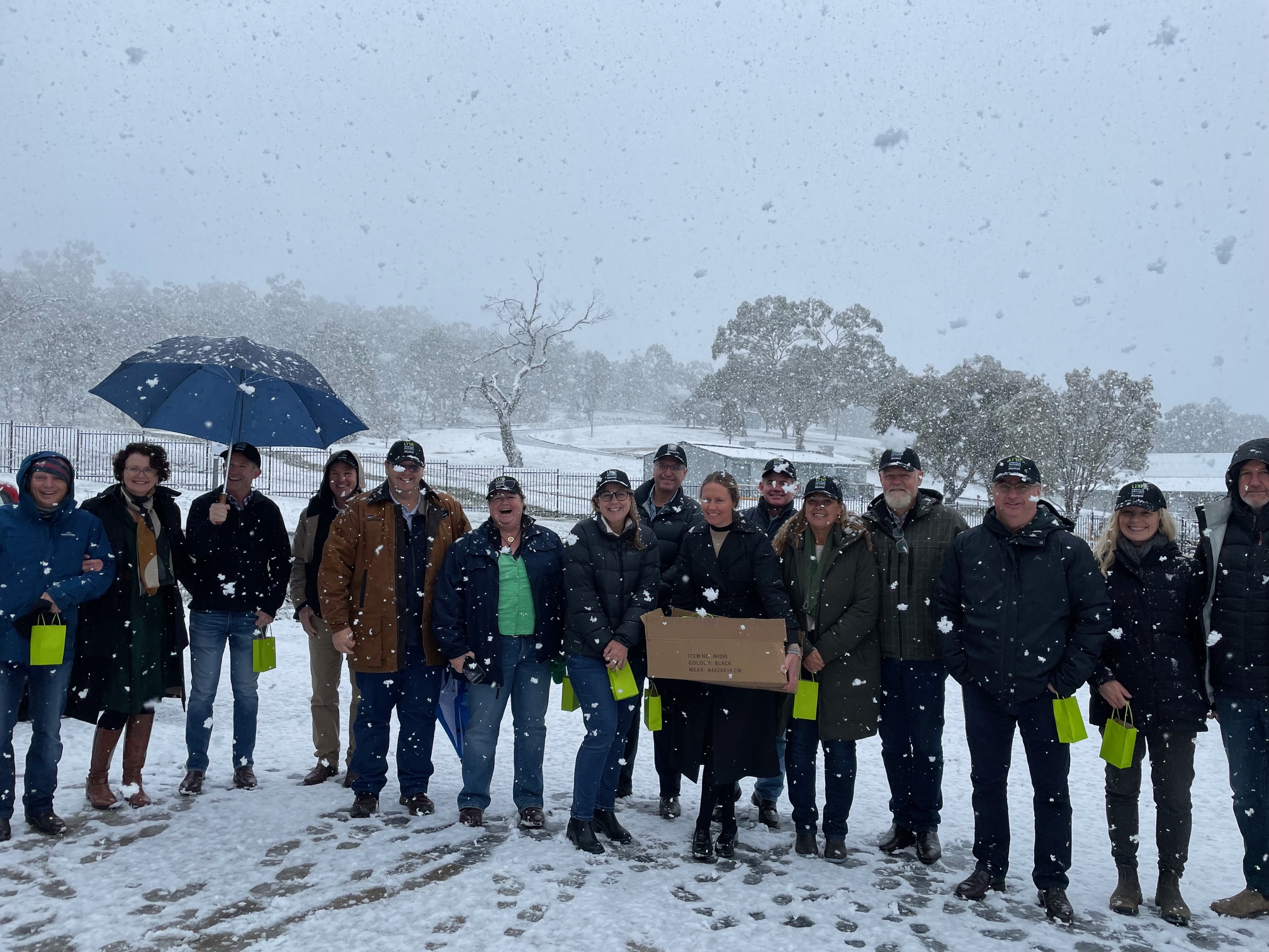 Rural Science class of 1994/95 standing and smiling in the snow on the UNE Armidale campus.