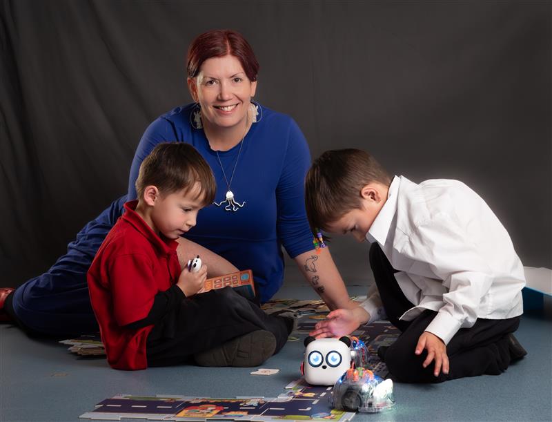 Jo Bird, UNE Associate Professor in Early Childhood Education, with her twin boys Declan and Callum and some of the robot toys she uses for teaching.  