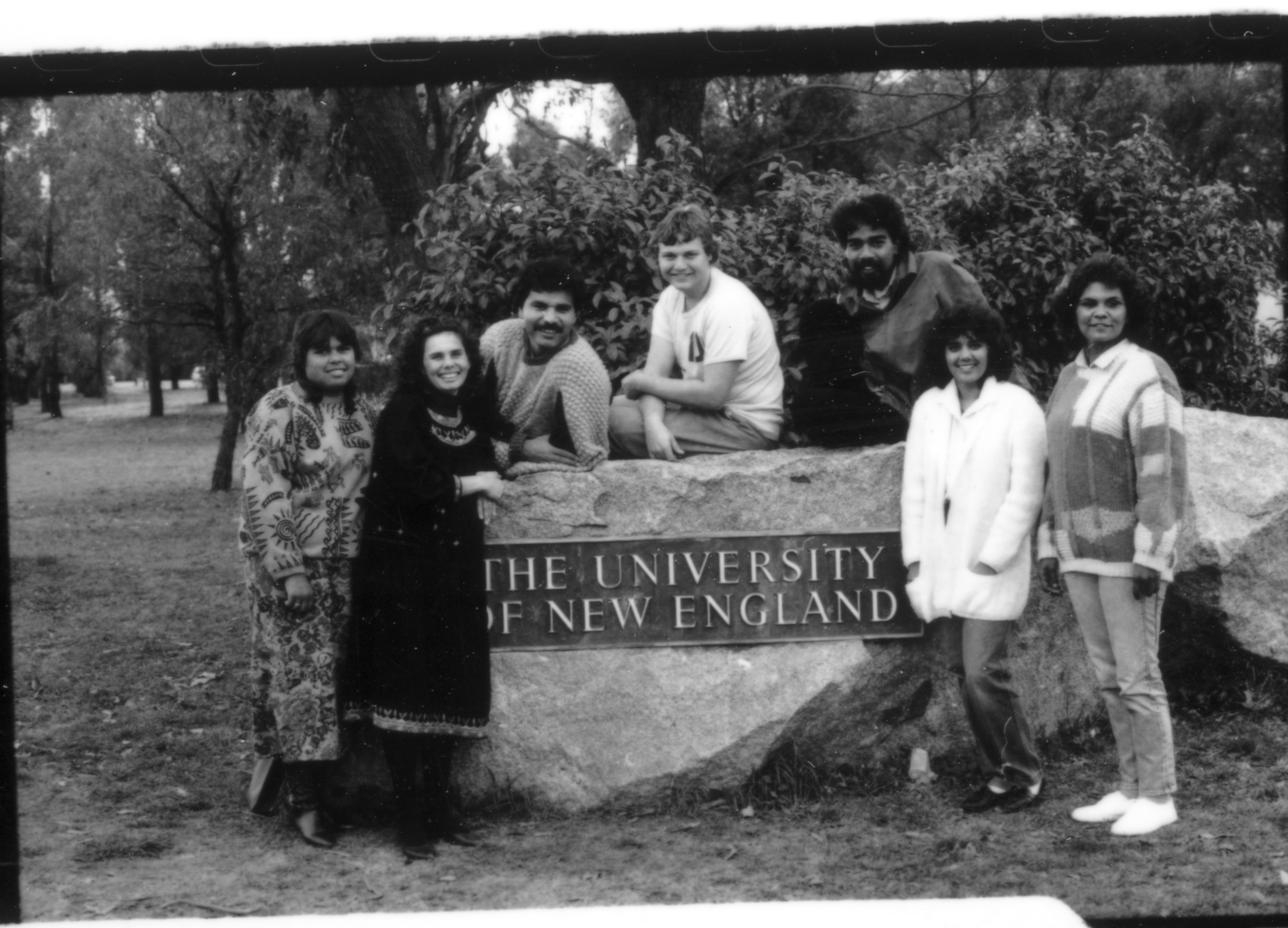 Group of Oorala founders and students stand around the UNE sign