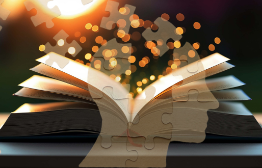 Open book on a table at sunset with glowing light particles rising from its pages, overlaid with the semi‑transparent outline of a human head made of interlocking jigsaw pieces, symbolising learning, cognition and the complexity of the mind.