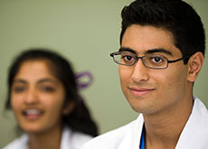 Young male medical student with female medical student in the background