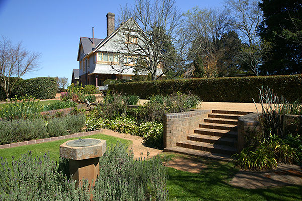 The gardens of Trevenna homestead showing stone steps and sundial 