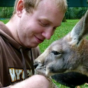 UNE graduate Michael Klepperich feeds kangaroo