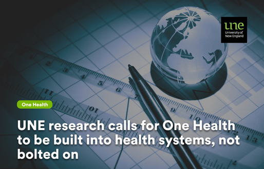 A stylised close up of a pen resting on a technical chart beside a small glass globe showing a map of the world, lit in cool blue tones. The UNE University of New England logo appears in the top right corner, and an on screen label reads “UNE research calls for One Health to be built into health systems, not bolted on,” signalling a focus on integrated, globally minded health planning.