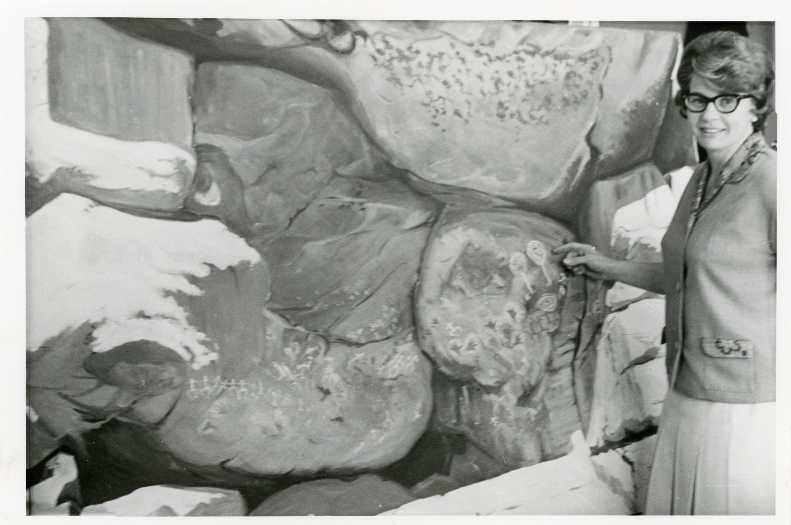 B/W image of woman with rock art