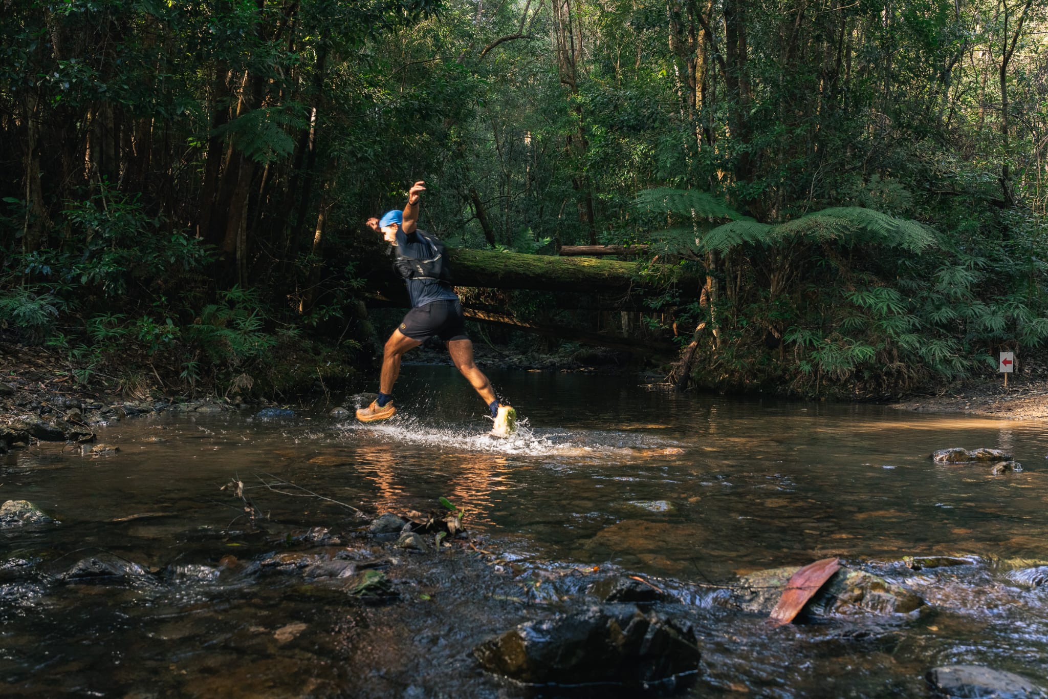 Mark McClelland running through a creek