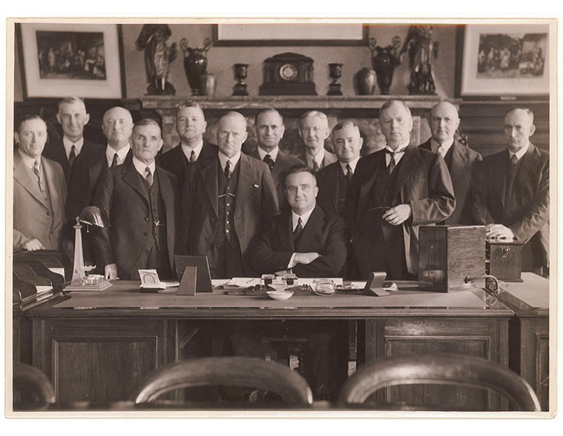 Black and white photo from 1939 of Premier Bertram Stevens and his cabinet in his office. 