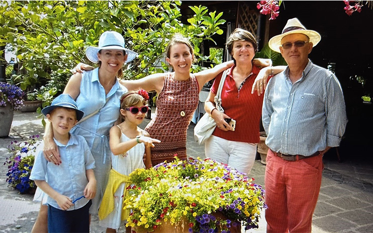 Périn smiling at camera with wife, daughters and grandchildren