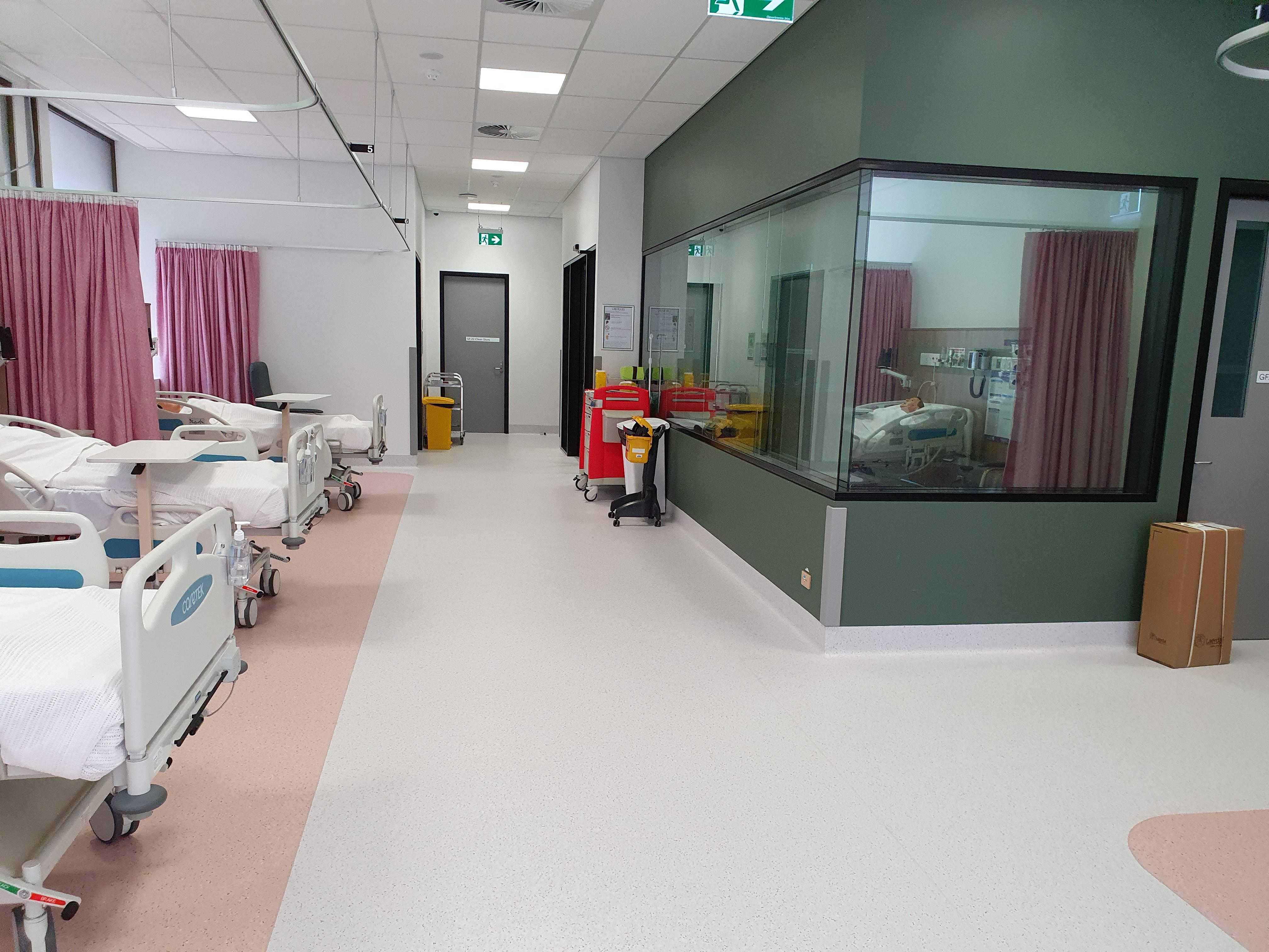 UNE nursing simulation ward showing several hospital beds.
