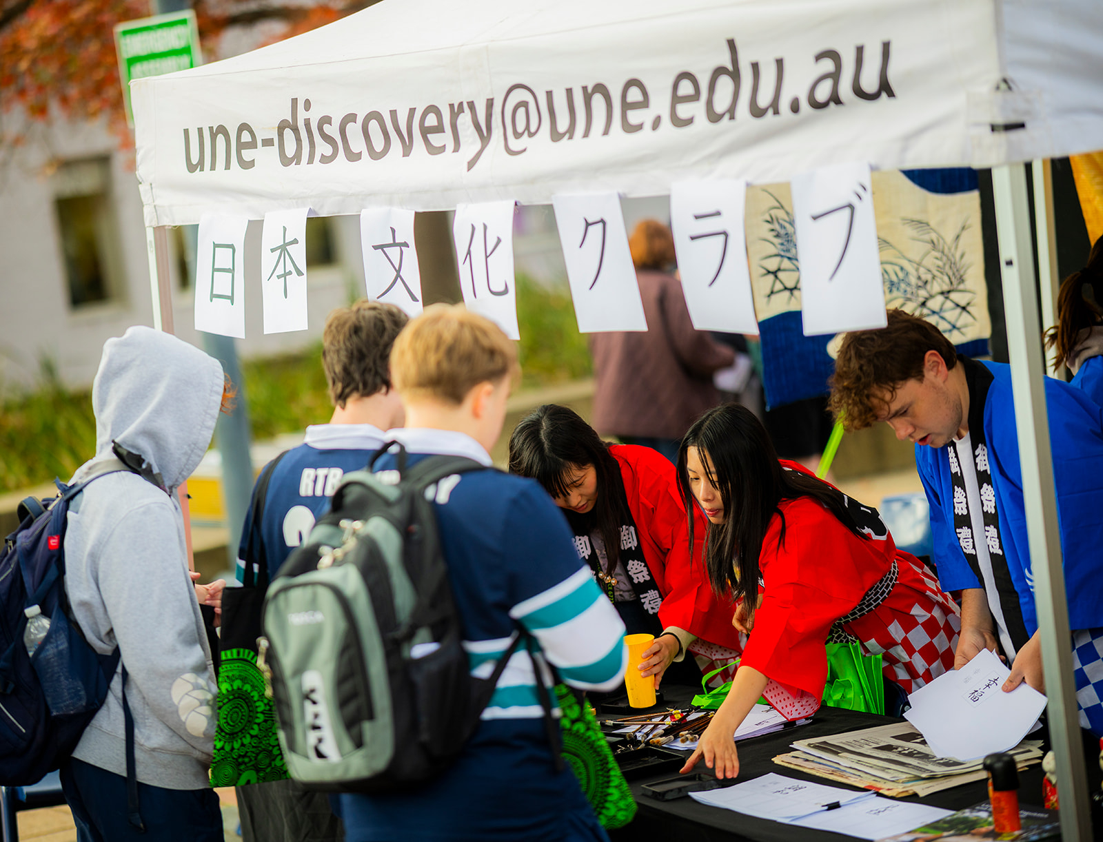 Local high school students exploring the Japanese stall 