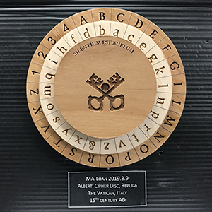 Replica of an Albert Cipher Disc from the 15th century, a coding device featuring concentric wooden wheels with lettering around the outside of each