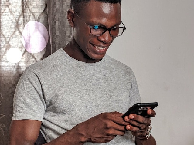 Man smiling looking at his mobile phone