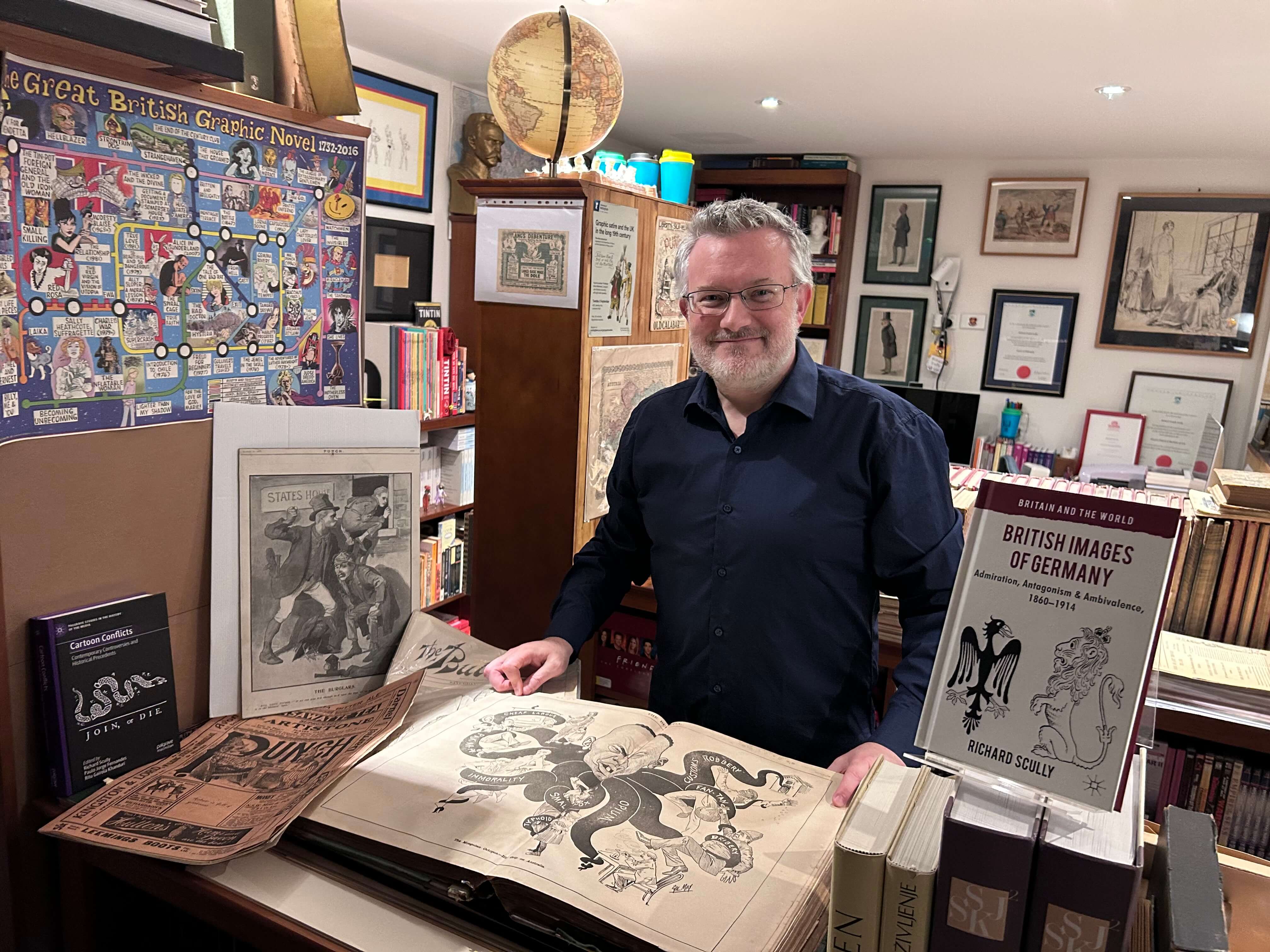 Richard among cartoons in his office.