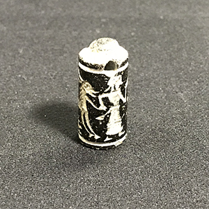 Tiny stone stamp with Eqyptian scene of a man selling a deer-like animal