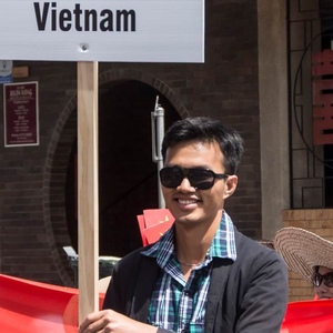 UNE Master of Science in Agriculture graduate Van Sang Lee with Vietnam sign in cultural parade