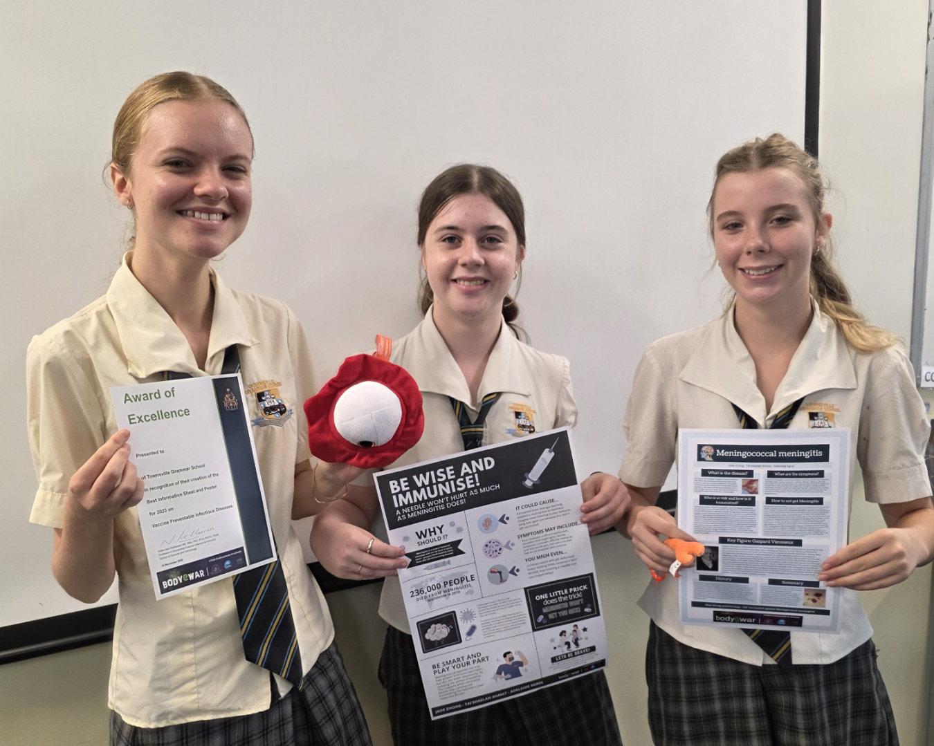 Students holding their posters and award