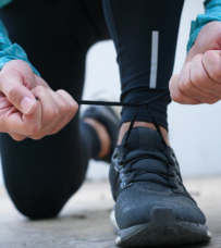 Person's hands tying shoe lace.