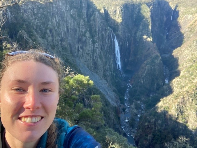 Amelia Wearing standing in front of a waterfall