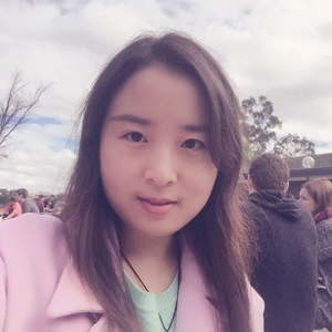 Close up of UNE graduate in pink coat