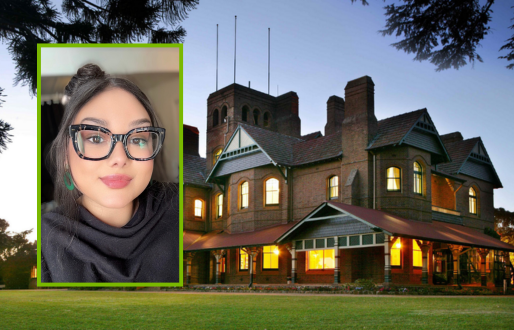 Head-and-shoulders portrait of a young woman with long dark hair tied in a high bun, wearing large black-framed glasses, subtle makeup with pink lipstick, and a black top, framed in a bright green rectangle. Her image is overlaid on a twilight exterior view of Booloominbah at the University of New England — a large historic brick mansion with lit windows, gabled roofs, and a lawn in the foreground, framed by dark tree branches at the top of the image.