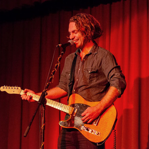 Music teacher and Master of Teaching (Primary) graduate Caleb Gorman playing electric guitar