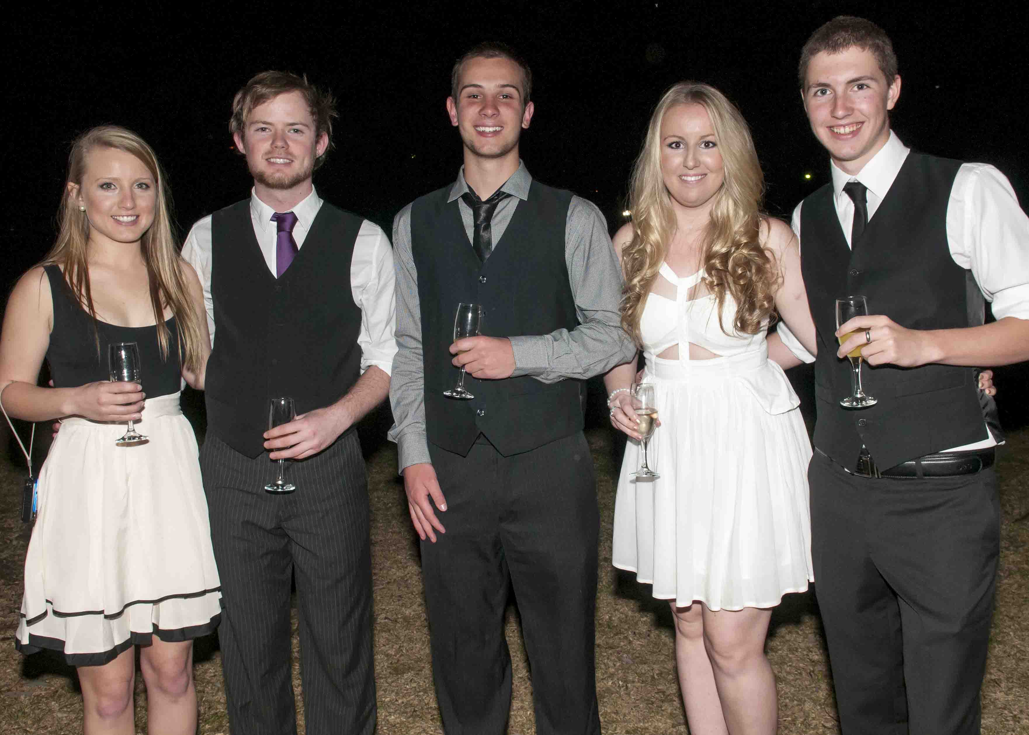 Students in formal attire with drinks