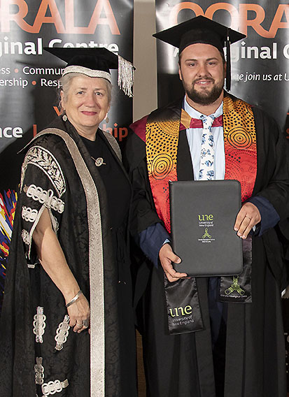 VC Prof Brigid Heywood and Marcus Froome in formal gowns at a graduation ceremony