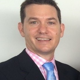 Close up of UNE graduate Hamish Shaw in business suit and tie