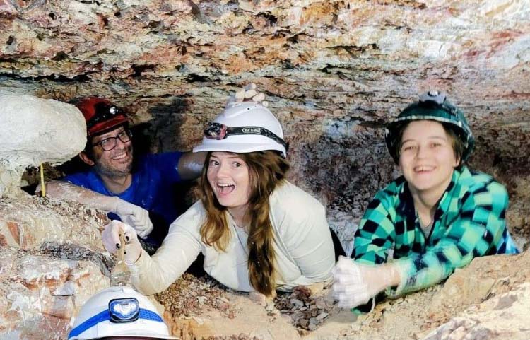 Olivia Devereaux, Nic Campione and a class mate in a rock cave during a field trip to Lightning Ridge. 