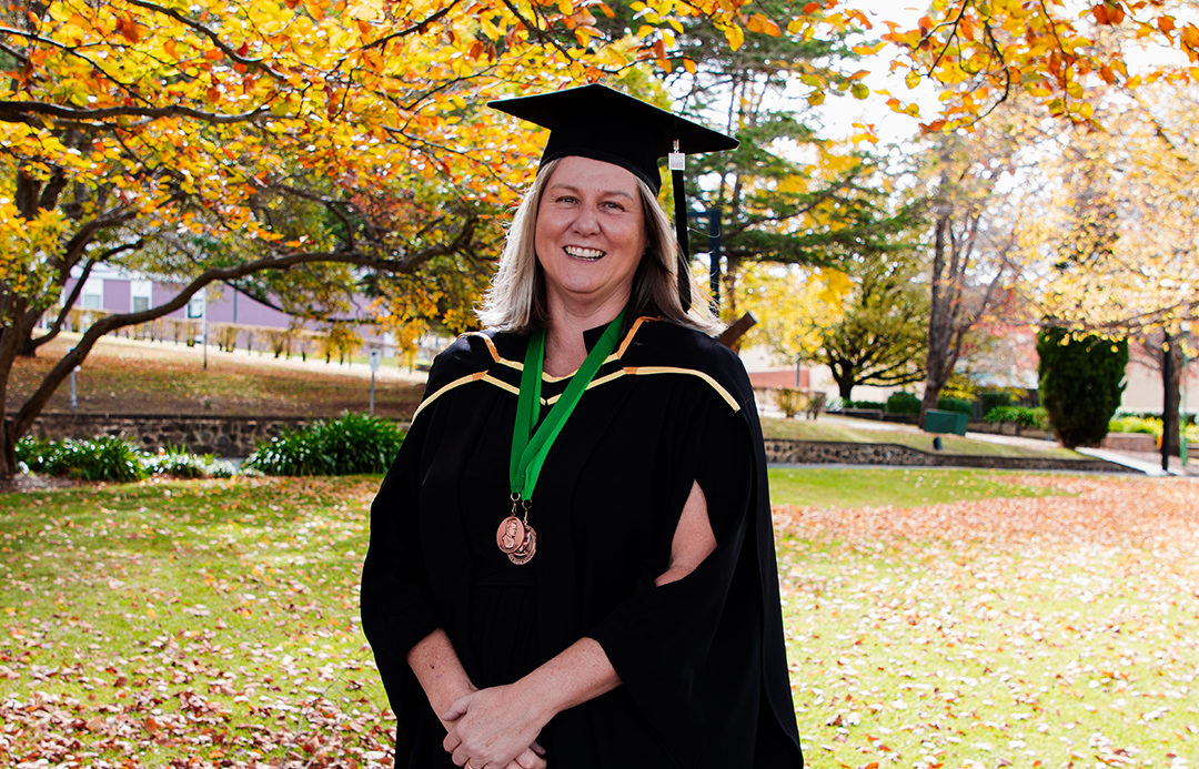 Shelley Rowntree wearing her academic robes and her two medals after the Autumn graduation ceremony.