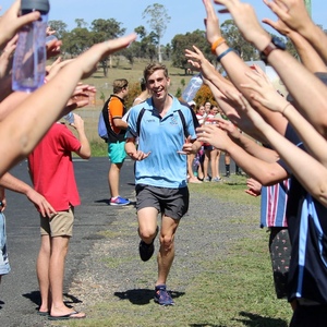 UNE Bachelor of Science (Genetics) student Dominic Waters completes fun run beneath canopy of hands